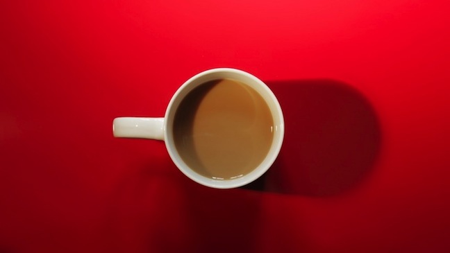 Kona Coffee in a cup on red table